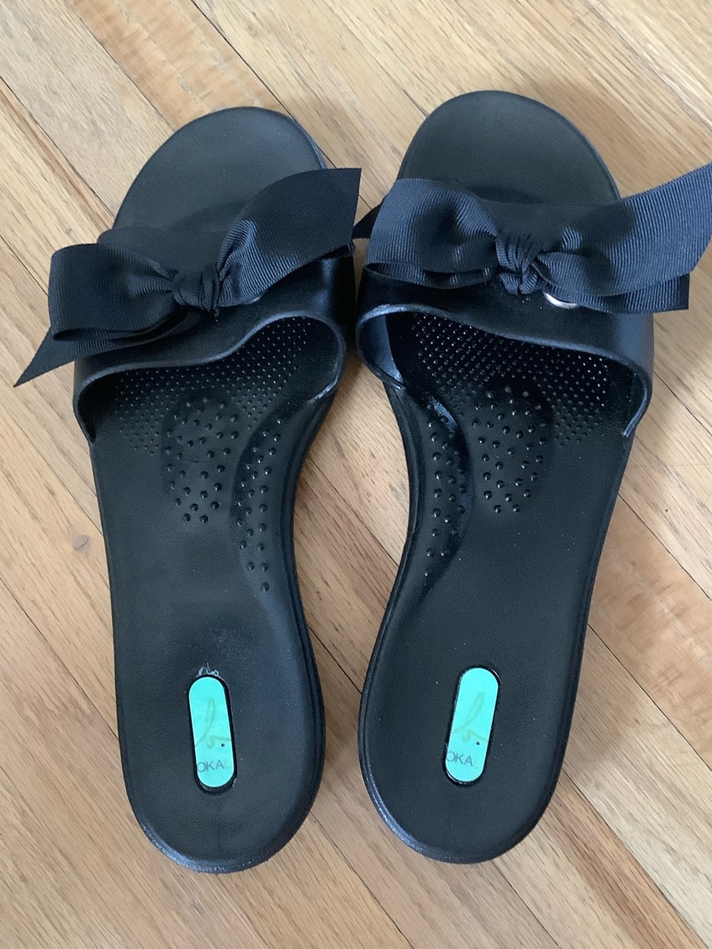 Okabashi Black Slide Sandals with Bow Accent and Teal Insole Detail